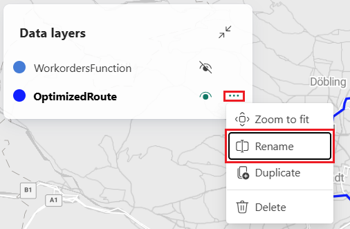 A screenshot of the Microsoft Fabric Maps Data layers panel showing two layers WorkordersFunction and OptimizedRoute. The OptimizedRoute layer has its options menu expanded with a red rectangle highlighting the Rename option. Other menu options visible include Zoom to fit, Duplicate, and Delete. The panel appears over a street map background showing the Vienna Austria area.