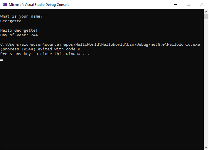 Screenshot des Fensters „Debug-Konsole“ mit der Eingabeaufforderung für einen Namen, der Eingabe und der Ausgabe „Hallo Georgette! Tag des Jahres: 244“.