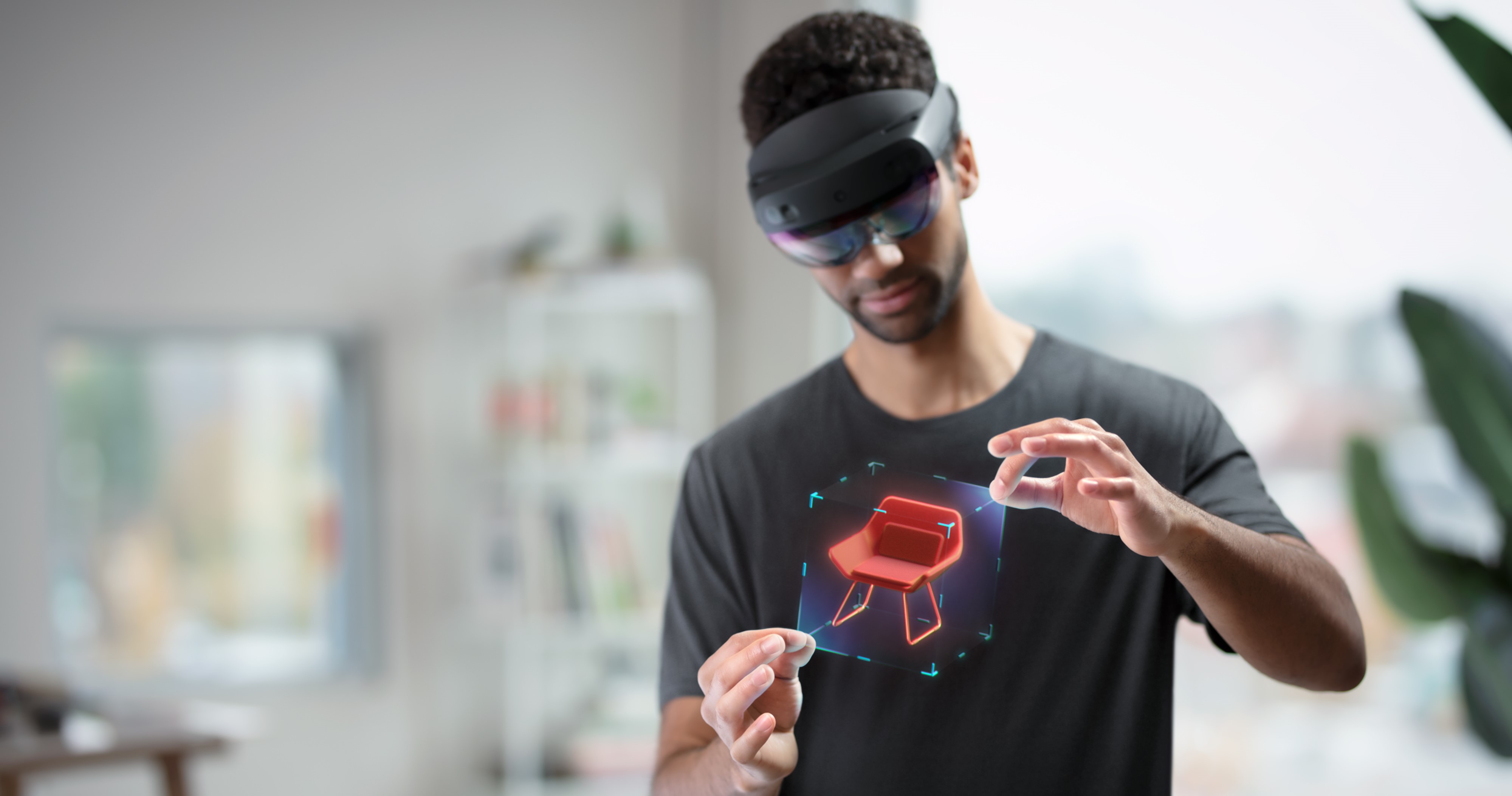 Immagine di un utente che indossa un HoloLens e manipola un ologramma con movimento della mano
