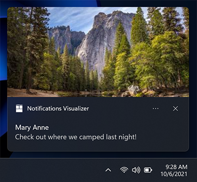 Uma captura de tela de uma notificação de aplicativo mostrando o posicionamento da imagem hero, acima da área de atribuição.